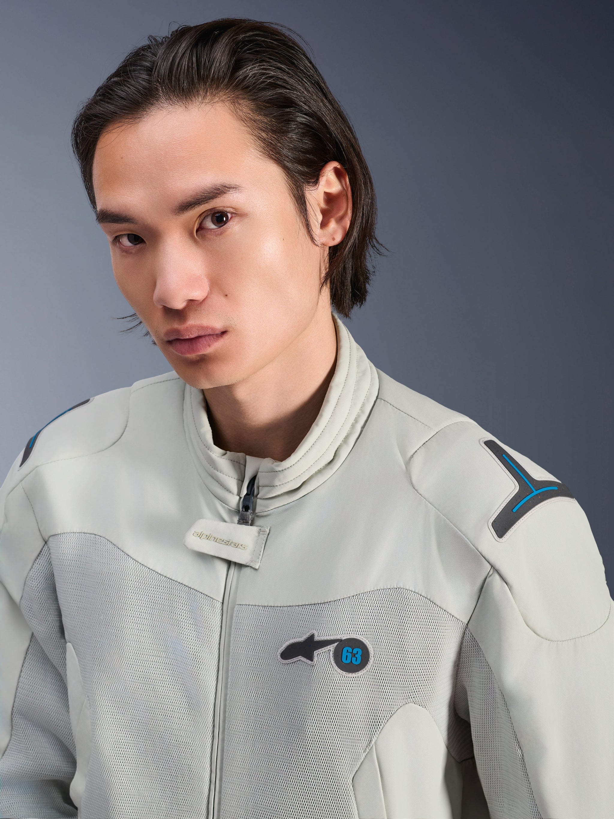 Alpinestars Circal-1 Air Jacket, Metal Gray with Methyl Blue accents, male model wearing urban summer motorcycle jacket, close-up of mesh airflow panels and minimalist branding on the chest