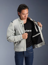 Alpinestars Circal-1 Air Jacket, Metal Gray, held open to show interior mesh lining and pocket details, worn by a model with a black logo t-shirt and blue jeans, urban motorcycle style