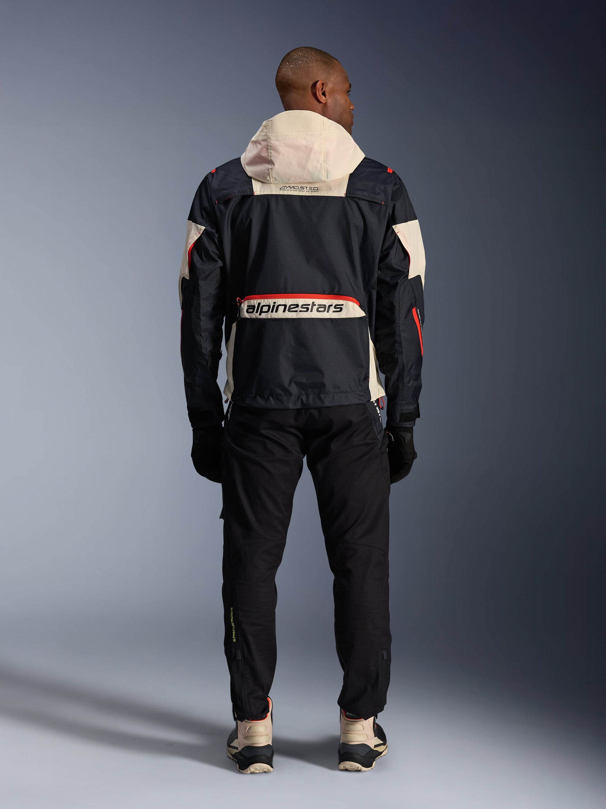 Alpinestars Mogress Air Jacket, rear view of a Men's Black and Hot Orange urban motorcycle jacket with a cream hood.