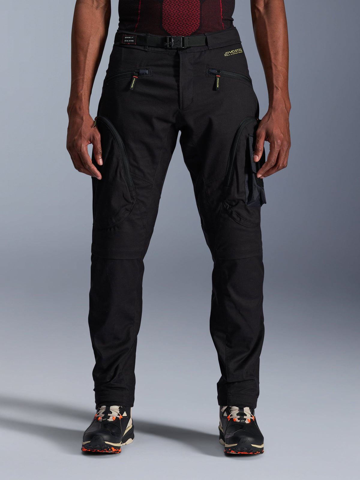 Alpinestars Acteon Pants, Black Urban Motorcycle Pants, tapered regular fit featuring side cargo pockets with reverse coil zippers, integrated waist belt and yellow branding, protective textile riding gear