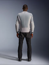 Alpinestars C-1 Air Jacket in Silver, viewed from the back on a male model, textile motorcycle jacket featuring large tech mesh ventilation panels, small black logo at the neck, and waist adjusters, worn with black riding pants for an urban contemporary look.