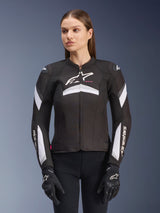 Alpinestars Stella T-GP Plus R V4 Jacket, Women's Textile Motorcycle Jacket, Black and White, worn by a female model, featuring white stripe accents on the sleeves and chest, Alpinestars logo branding, sport fit construction with a front zipper closure