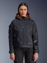 Alpinestars Molly Air Jacket, Women's Motorcycle Urban Jacket, Black with Fluo Coral interior lining, worn by a female model, hooded design with technical textile construction, zippered pockets and Alpinestars logo on the sleeve
