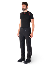 Alpinestars Alden Pants, Urban Motorcycle Pants, Black, regular fit softshell textile, worn by a model with a black base layer and riding shoes, featuring a waist belt with magnetic closure and zippered pockets.