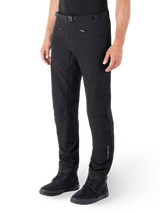 Alpinestars Alden Pants, Urban Motorcycle Pants, Black, technical softshell fabric with regular fit, featuring magnetic waist buckle, quilted side panels, zippered pockets, and subtle branding on the lower leg, worn with black riding shoes