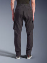 Alpinestars Flex-AST Cargo Pants - Short, Urban Motorcycle Pants, Black, back view showing a regular tapered fit with elasticated hems, large side cargo pockets, and subtle branding on the back pocket, worn with casual sneakers