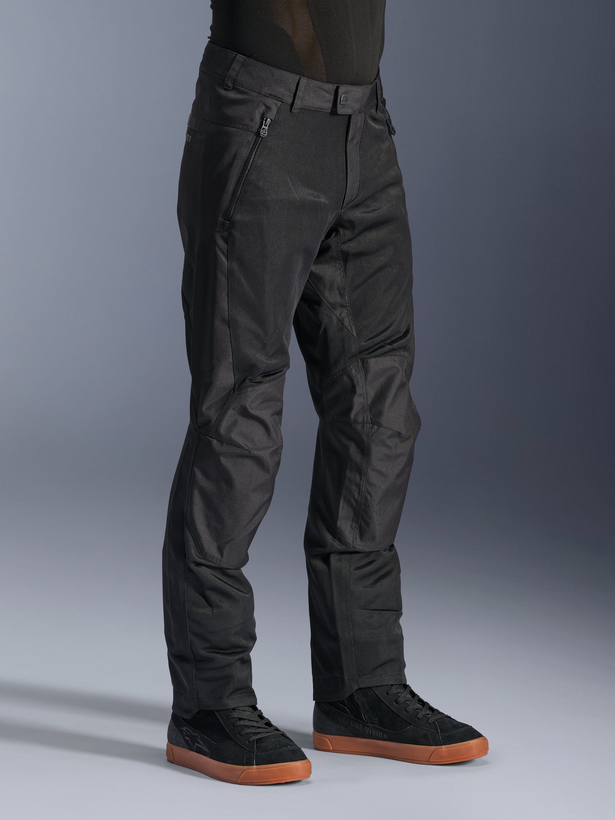Alpinestars C-1 Air Pants, Urban Motorcycle Pants, Black, featuring breathable tech mesh panels and polyfabric construction, worn with black sneakers, clean and functional design for city riding.