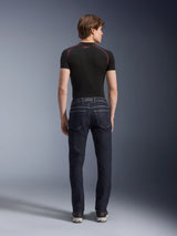 Alpinestars Copper V3 Denim Pants in Rinse Blue, urban motorcycle jeans shown from the rear, featuring a straight leg regular fit and back pockets, worn with a black short-sleeve top and sneakers.