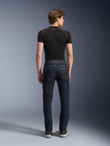 Alpinestars Copper V3 Denim Pants in Rinse Blue, urban motorcycle jeans shown from the rear, featuring a straight leg regular fit and back pockets, worn with a black short-sleeve top and sneakers.