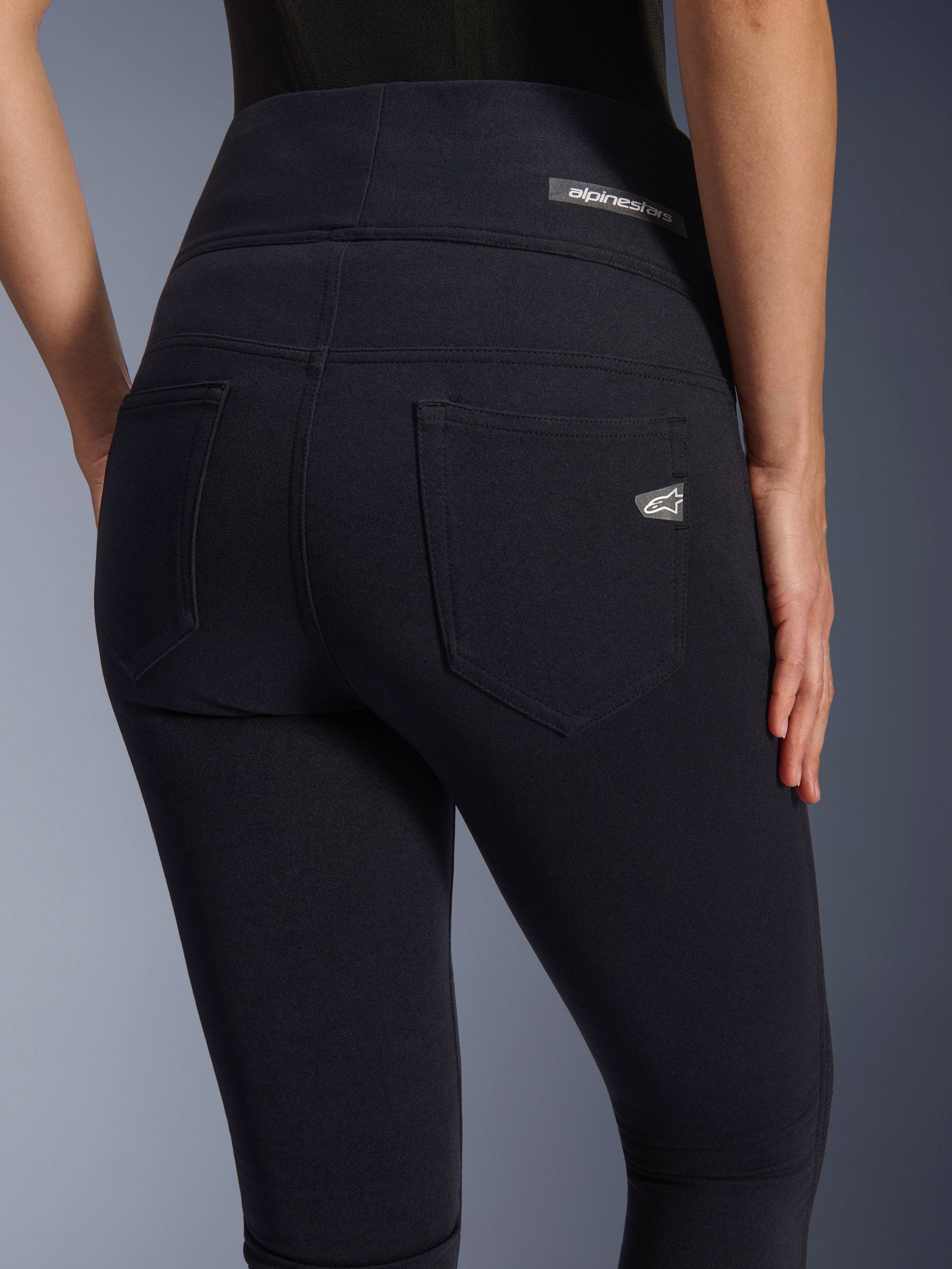 Alpinestars Stella Flex-AST Leggings, Women's Motorcycle Riding Pants, Black, close-up back view highlighting the high-waisted design, two functional rear pockets, and Alpinestars logo labels on the pocket and waistband.