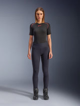 Alpinestars Stella Flex-AST Leggings, women's urban motorcycle leggings in Black, skinny high-waisted design worn with a black short-sleeve technical top and black riding boots, featuring accordion knee panels and a contemporary minimalist look