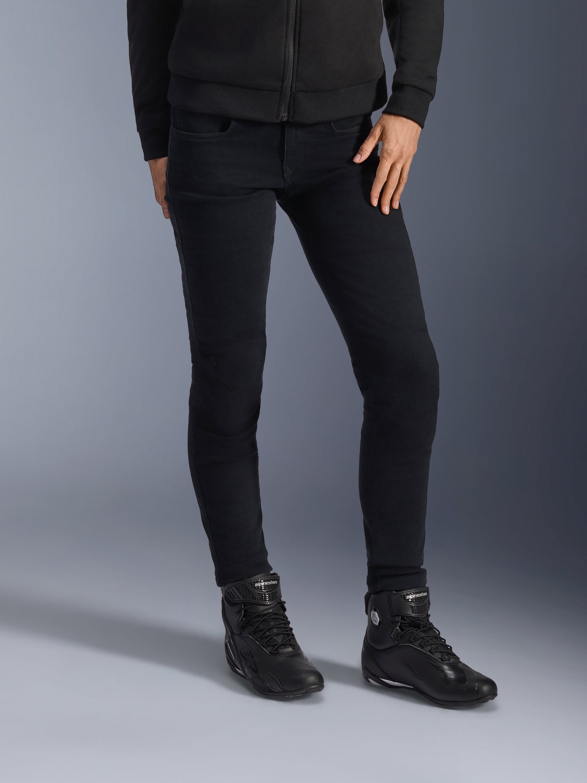 Alpinestars Daisy V3 Women's Riding Denim, Rinse Black, slim-fit motorcycle jeans, paired with black high-top riding boots and zip-up hoodie, sleek monochrome urban styling