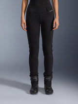 Alpinestars Womens Banshee Leggings, Black motorcycle pants, slim-fit design with accordion knee panels, worn with black high-top riding boots, urban road gear with a casual style