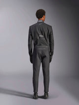 Alpinestars Hypertech V3 Suit, Black Dark Shadow, rear view of a professional one-piece auto racing suit, featuring FIA certification label on the collar and 'Alpinestars' and 'RACING AHEAD' branding on the lower back, worn with matching black racing gloves and boots.