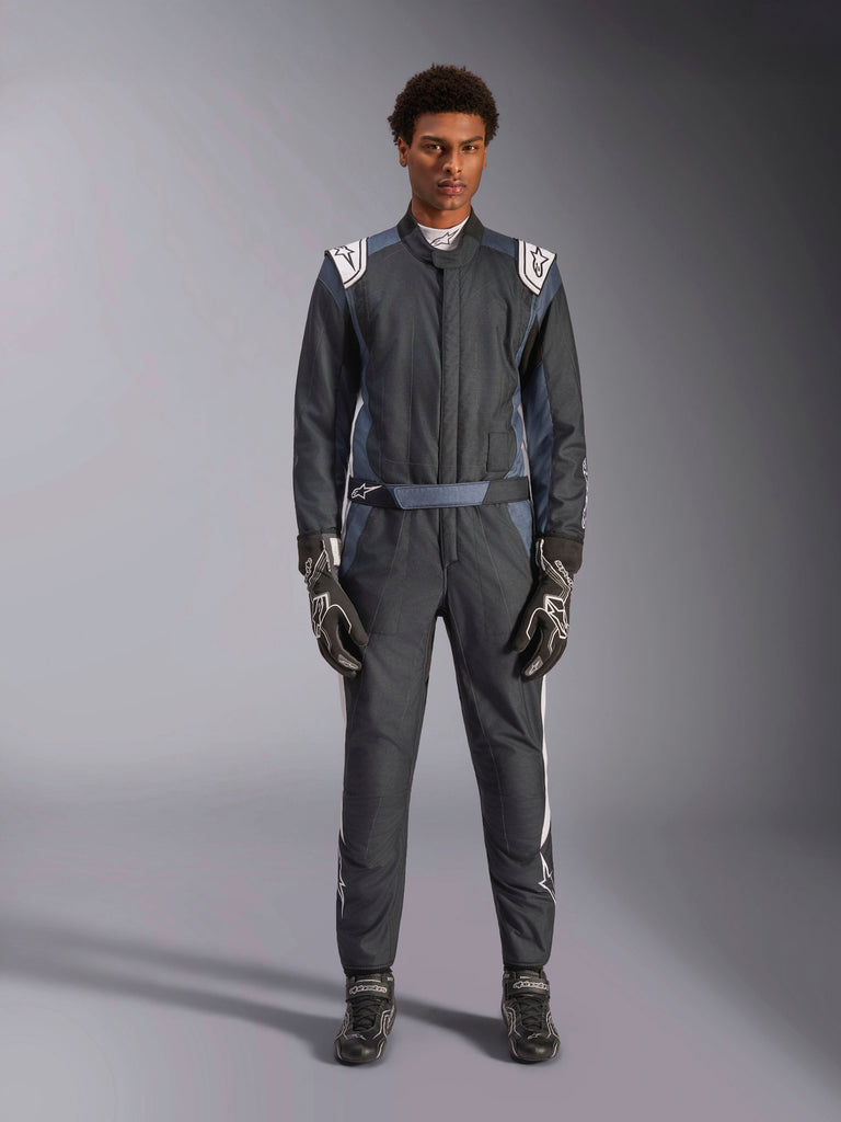 Alpinestars GP Pro Comp V2 FIA Suit, Black Asphalt White, professional one-piece auto racing suit worn with matching gloves and boots, featuring white shoulder panels with black star logos and white side stripes, designed for circuit driving