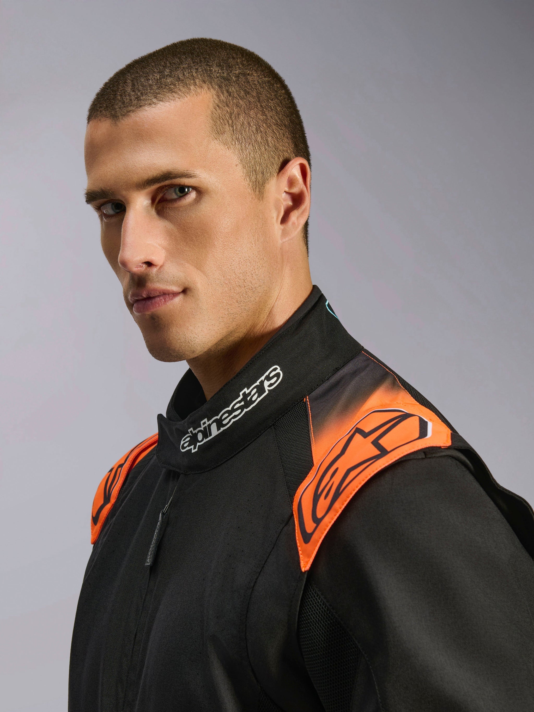 Alpinestars KMX-5 V3 Suit, Karting Suit, Black and Orange Fluo, FIA certified, on-model detail of collar and shoulders.