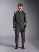 Alpinestars GP Tech V4 Suit, Black and White, professional one-piece auto racing suit, worn with matching black and white gloves and racing shoes, featuring white Alpinestars logos on shoulders and collar, sleek athletic fit for motorsport competition