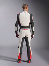 Alpinestars GP Tech V4 Suit, Auto Racing Suit, White Black and Red, back view of driver wearing the one-piece suit, featuring black stretch panels on the sides and shoulders, red accents on the lower legs, Alpinestars branding on the lower back and collar, professional FIA-certified motorsport gear