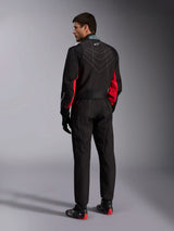 Alpinestars KMX-9 V3 Suit, Black Red White, one-piece karting suit shown from the back, featuring white geometric stitching on the back and red accents on the sleeves, worn with black racing gloves and karting shoes.