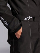 Alpinestars KMX-9 V3 Suit, Black and White, close-up view of adjustable waist belt with embroidered logo, side pocket, white contrast stitching on black fabric, technical karting suit detail
