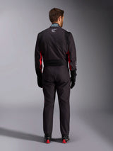 Alpinestars KMX-9 V3 Graphic 3 Suit, Karting Suit, Black and Red, rear view featuring the lumbar stretch panel and FIA certification tag on the collar, styled with black racing gloves and red-accented boots