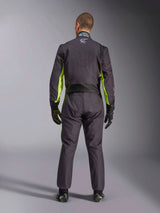 Full-body rear view of a person wearing the Alpinestars KMX-9 V3 Graphic 3 Suit, Karting Suit in Black and Yellow Fluo, showing ergonomic stretch panels on the back and shoulders, paired with black racing gloves and footwear.