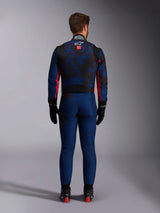 Karting driver from the back wearing the KMX-9 V3 Graphic 5 Suit in Navy Red, featuring a navy blue and black graphic pattern, red side accents, and the Alpinestars logo on the upper back, paired with black racing gloves and footwear.