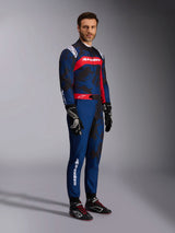 Model wearing the Alpinestars KMX-9 V3 Graphic 5 Suit in Navy Red, full-body shot including black karting gloves and black racing shoes, navy blue suit with dark camo-style graphics and a prominent red chest panel with white branding, professional karting protective gear