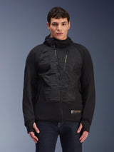 Alpinestars MO.ST.EQ Hybrid Hooded Jacket, Black urban motorcycle jacket, model wearing mid-season padded hoodie with angled front zipper, seamless padded chest panels, thumb loops, and a hood, modern streetwear-inspired riding gear