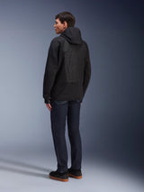 Alpinestars MO.ST.EQ Hybrid Hooded Jacket, Black, urban motorcycle hoodie featuring a seamless padded back panel, rear view, worn with dark denim jeans and black sneakers, modern motorsport-inspired streetwear style.