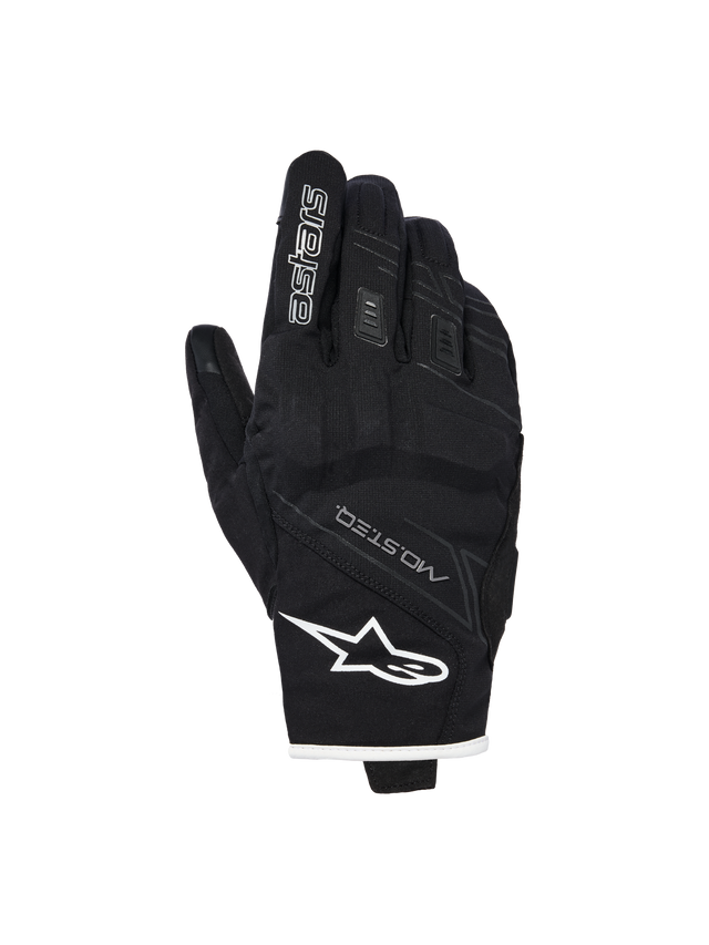 Alpinestars Stella Moblast Waterproof Gloves, Women's Motorcycle Gloves, Black with white trim, backhand view showing Alpinestars logo, MO.ST.EQ branding, and soft knuckle protection.