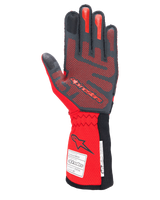 Alpinestars Tech-1 ZX V4 Gloves, Auto Racing Gloves, Black and Red, palm side showing red 3D silicone grip patterning and FIA/SFI homologation labels on the cuff, designed for high-performance motorsport