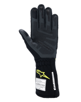 Alpinestars Tech-1 ZX V4 Gloves, Auto Racing Gloves, Tar Gray and Black with Yellow Fluo logo, palm view showing textured 3D silicone grip and FIA/SFI safety certification labels, professional motorsport equipment