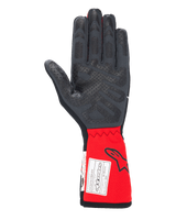 Alpinestars Tech-1 Race V4 Gloves, Auto Racing Gloves, Black and Red, palm view highlighting silicone grip patterns on fingers and palm, extended red cuff featuring Alpinestars logo and FIA certification label, high-performance motorsport gear