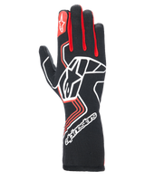 Alpinestars Tech-1 Race V4 Gloves, Auto Racing Gloves, Black with Red and White accents, featuring a large white star logo on the backhand, red finger gussets, white branding on the extended gauntlet cuff, and geometric design patterns.