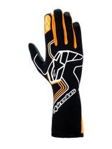 Alpinestars Tech-1 Race V4 Gloves, Auto Racing Gloves, Black and Orange Fluo, featuring a large white Astar logo on the back of the hand, orange finger accents, and a high-cuff gauntlet design for professional motorsports protection