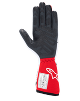 Alpinestars Tech-1 Race V4 Gloves, Auto Racing Gloves, White and Red, palm view featuring textured black silicone grip patterns and an FIA 8856-2018 certification label on the red gauntlet cuff, professional motorsport gear