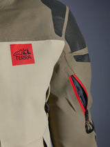 Alpinestars Nazca 3L GORE-TEX PRO Jacket, Walnut Rock Brown, detail of the back shoulder and sleeve, red 'ALL TERRA' logo patch, textured black Superfabric shoulder panels, zippered arm vent with red trim, premium adventure motorcycle apparel.