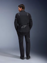 Alpinestars ST-7 2L GORE-TEX Jacket and matching ST-7 2L GORE-TEX Pants, Black and Dark Gray adventure motorcycle gear, rear view showing reflective Alpinestars logo on the jacket and technical textile construction.
