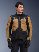 Alpinestars ST-7 2L GORE-TEX Jacket, Motorcycle Adventure Touring Jacket, Gobi Brown and Black with orange accents, worn by a male model, featuring Exploration Equipment branding and GORE-TEX technology, durable waterproof riding gear.