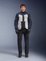 Alpinestars ST-7 2L GORE-TEX Jacket, Adventure Touring Motorcycle Jacket, Ice Gray Dark Blue and Black, worn with black pants and gloves, featuring large front cargo pockets, red accents on the sleeves, and a laminated GORE-TEX shell for waterproof performance.