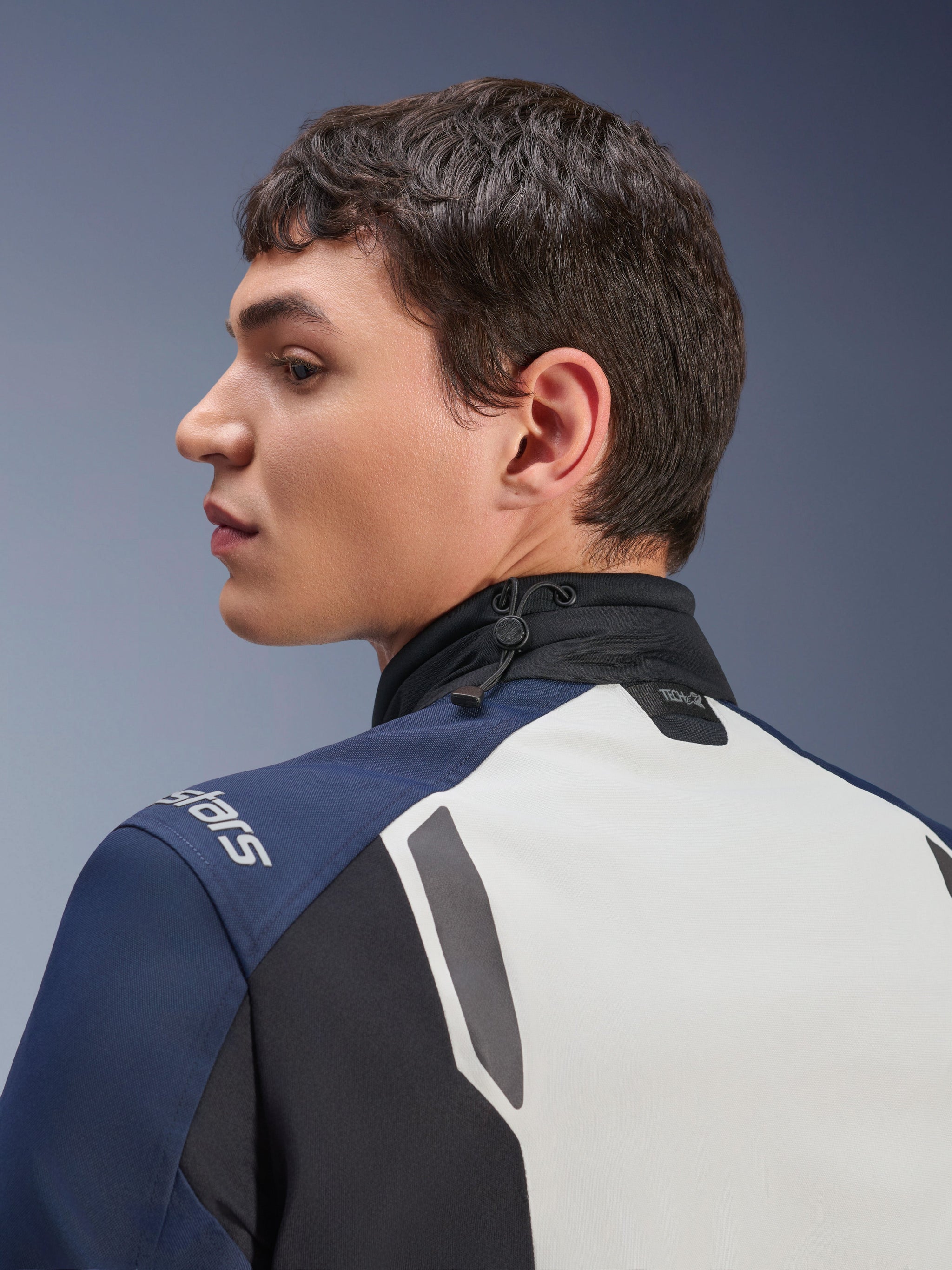 Alpinestars ST-7 2L GORE-TEX Jacket, close-up profile view of the back and neck area, Ice Gray Dark Blue and Black, featuring an adjustable shock cord collar and Tech-Air branding, premium adventure touring motorcycle jacket.