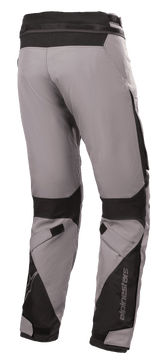 Alpinestars Road Pro GORE-TEX Pants, Motorcycle Touring Pants, Dark Gray and Black, rear view featuring technical textile construction, black ballistic nylon reinforcements, adjustable straps at the knees and ankles, and Alpinestars branding.