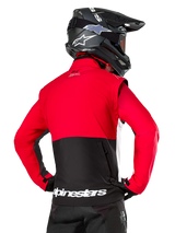 Alpinestars Pro-Dura Jacket, Off-Road Enduro Jacket, Red and Black with white Alpinestars logo on back hem, worn by rider from behind with a black motocross helmet, rally-inspired design for aggressive trail riding