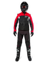 Motocross rider wearing complete off-road gear, Alpinestars Pro-Dura Jacket in Black, Bright Red, and White, black pants with red accents, black helmet with red goggles, black and white boots, coordinated outfit for enduro and trail riding