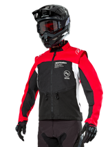 Alpinestars Pro-Dura Jacket, Off-Road Enduro Motorcycle Jacket, Black with Bright Red and White color blocking, worn by a rider with a black helmet and goggles, featuring front zippered pockets and Alpinestars branding, durable textile construction for trail riding