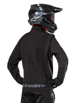 Alpinestars Lite-Dura Softshell Jacket, Black, back view worn by a rider, featuring gray Alpinestars branding on the rear hem and a small red logo on the collar, paired with a black motocross helmet, designed for enduro and off-road riding.