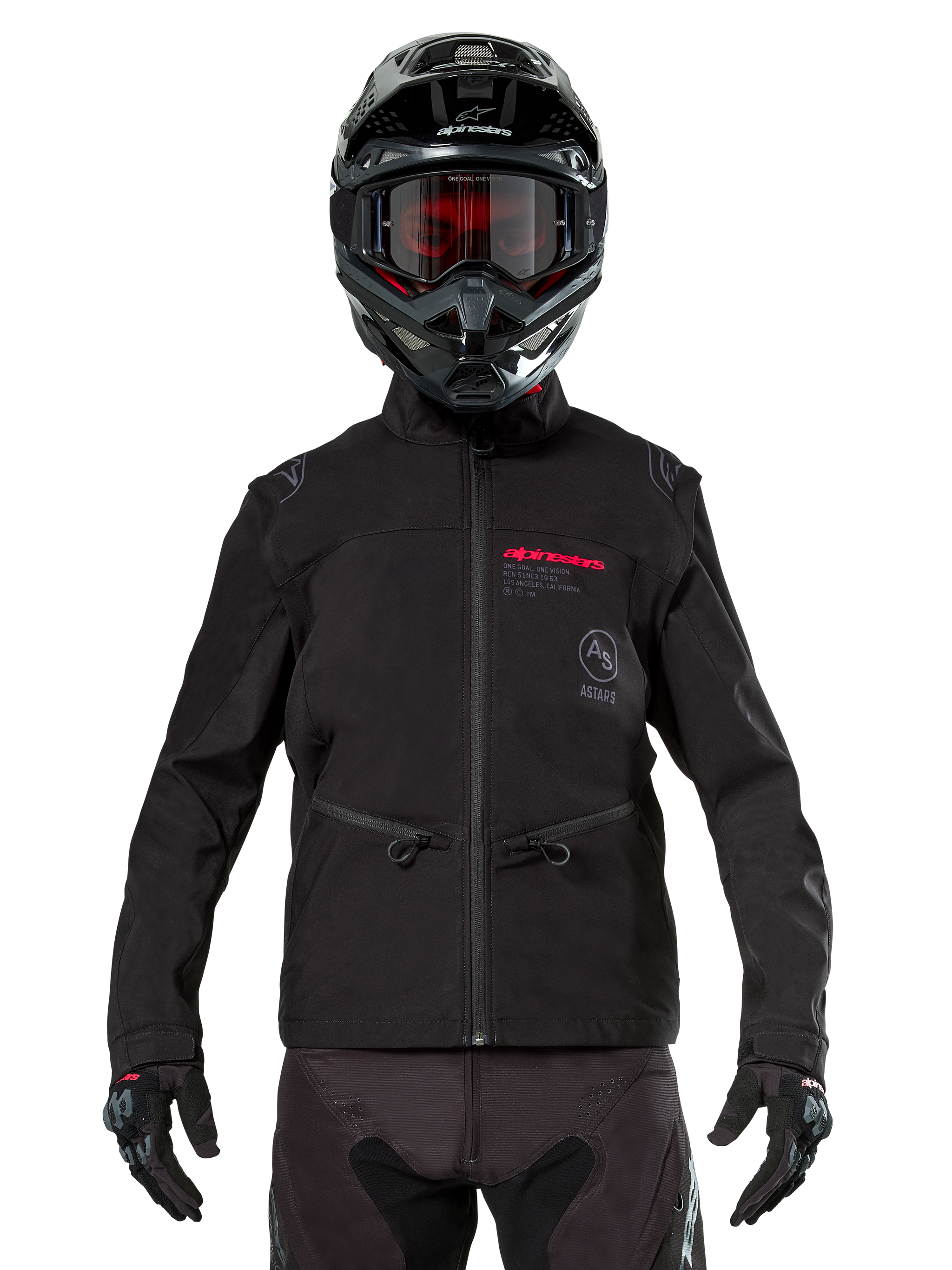 Motocross rider wearing Alpinestars Lite-Dura Softshell Jacket in Black, featuring red and grey logo details on the chest, black helmet with red-tinted goggles, black gloves and pants, front view of technical off-road riding apparel