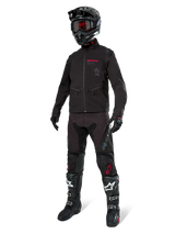 Alpinestars Lite-Dura Softshell Jacket, Black, worn by a mannequin as part of a complete off-road gear set including black pants, black and white boots, black helmet with red goggles, professional motocross and enduro apparel.