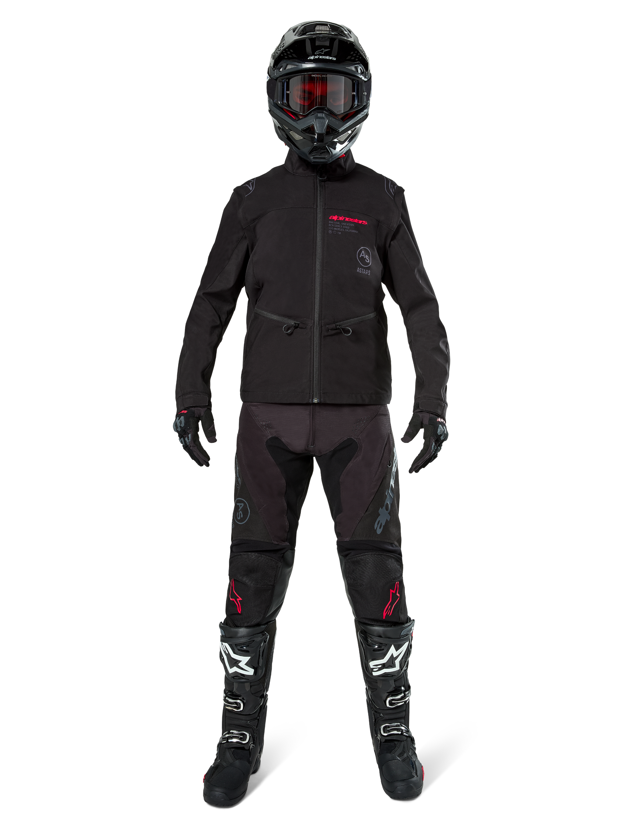 Motocross rider wearing the Alpinestars Lite-Dura Softshell Jacket in Black with red logo details, styled with matching black off-road pants, black helmet, and white and black boots, complete professional enduro racing gear.
